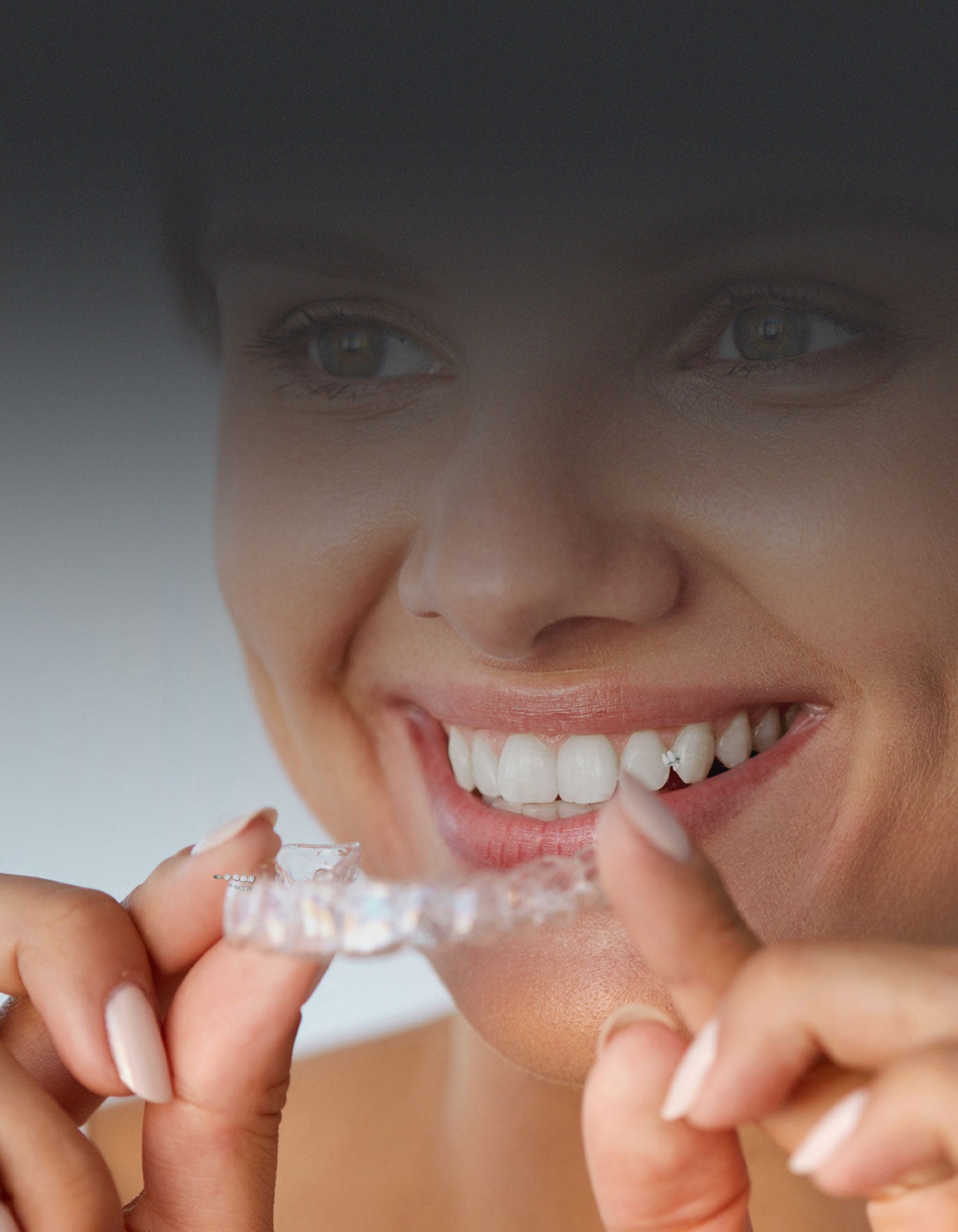 Orthodontic patient holding clear aligner
